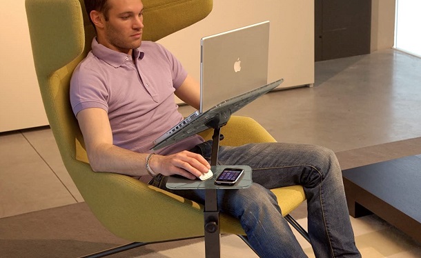 man sitting in the lounge chair with a stand