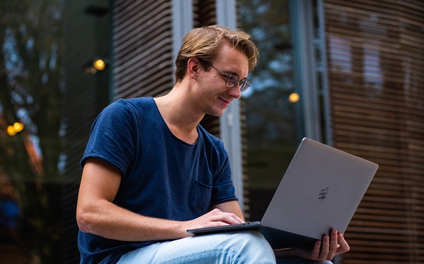 man reading on laptop